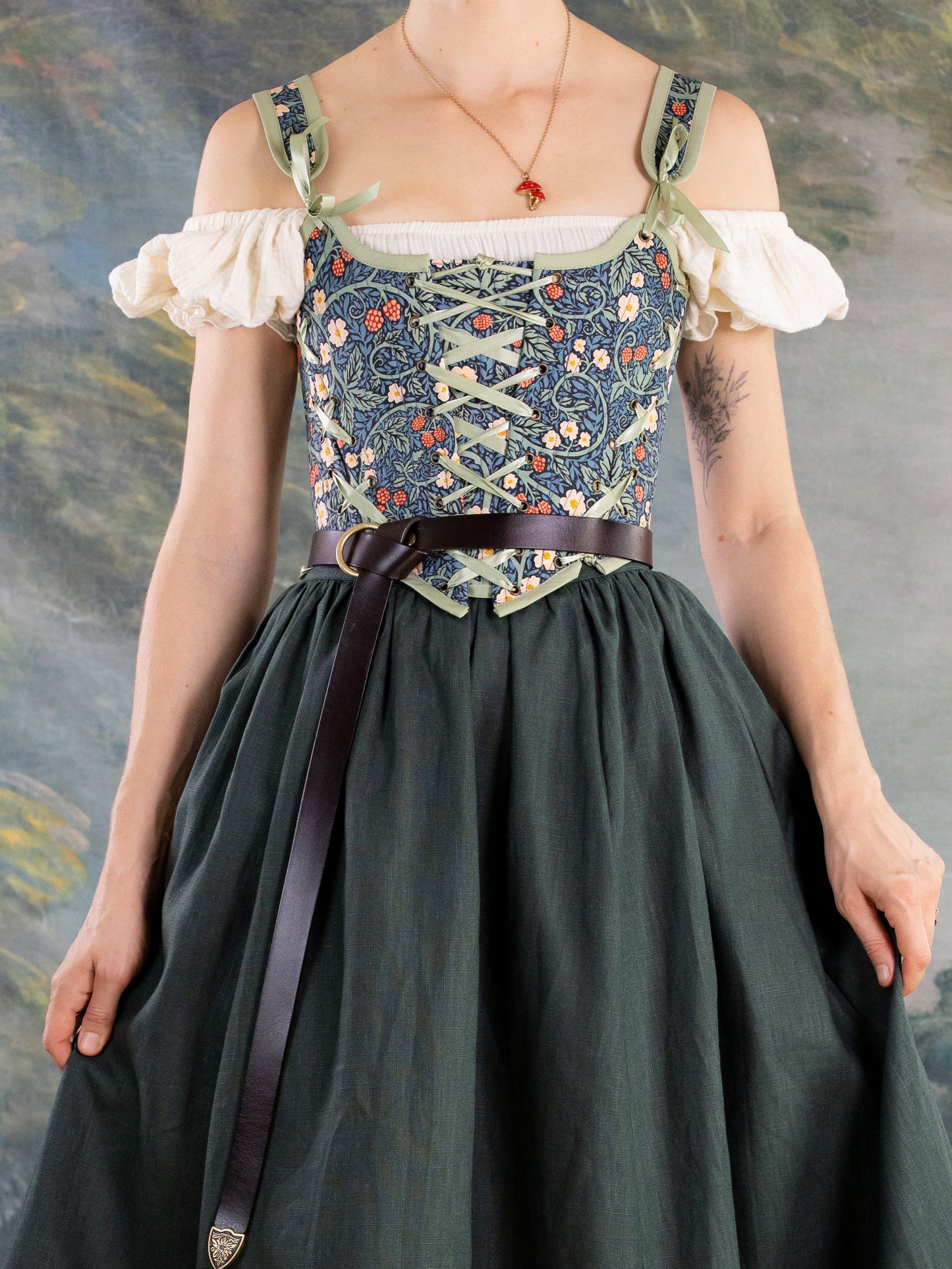 Raspberry Vines Princess Stays corset with adjustable lacing and floral pattern worn over off-shoulder blouse and dark skirt
