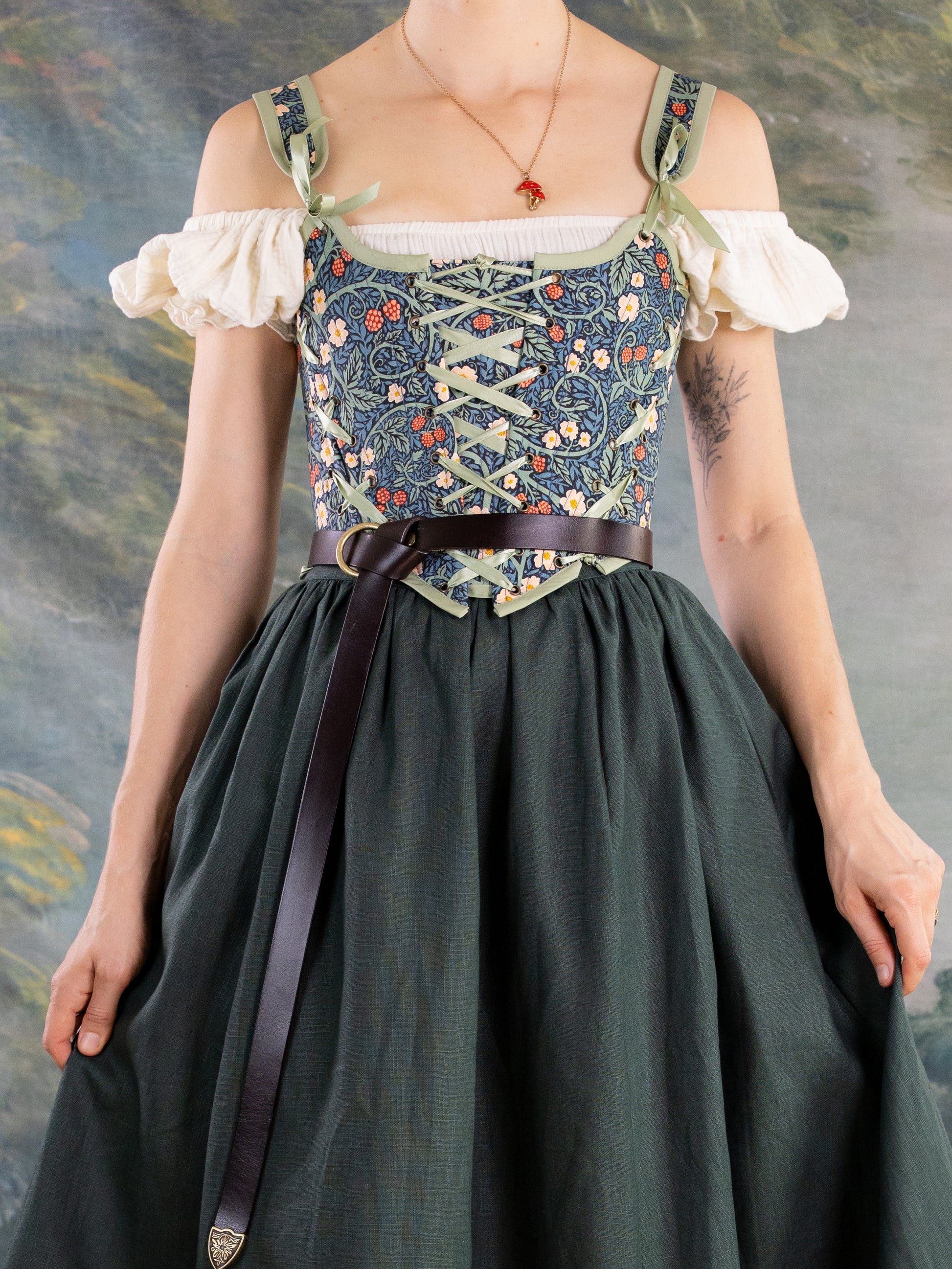 Raspberry Vines Princess Stays corset with adjustable lacing and floral pattern worn over off-shoulder blouse and dark skirt