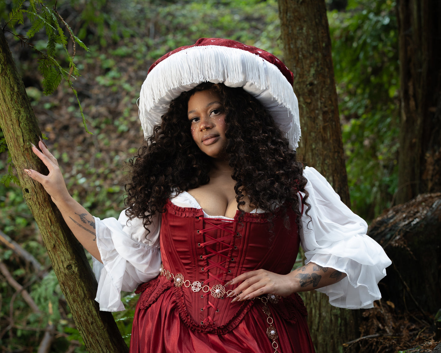 Woman wearing Red Satin 18th Century Stays with ruffle trims and lace-up front in a forest, gallery image two landscape orientation