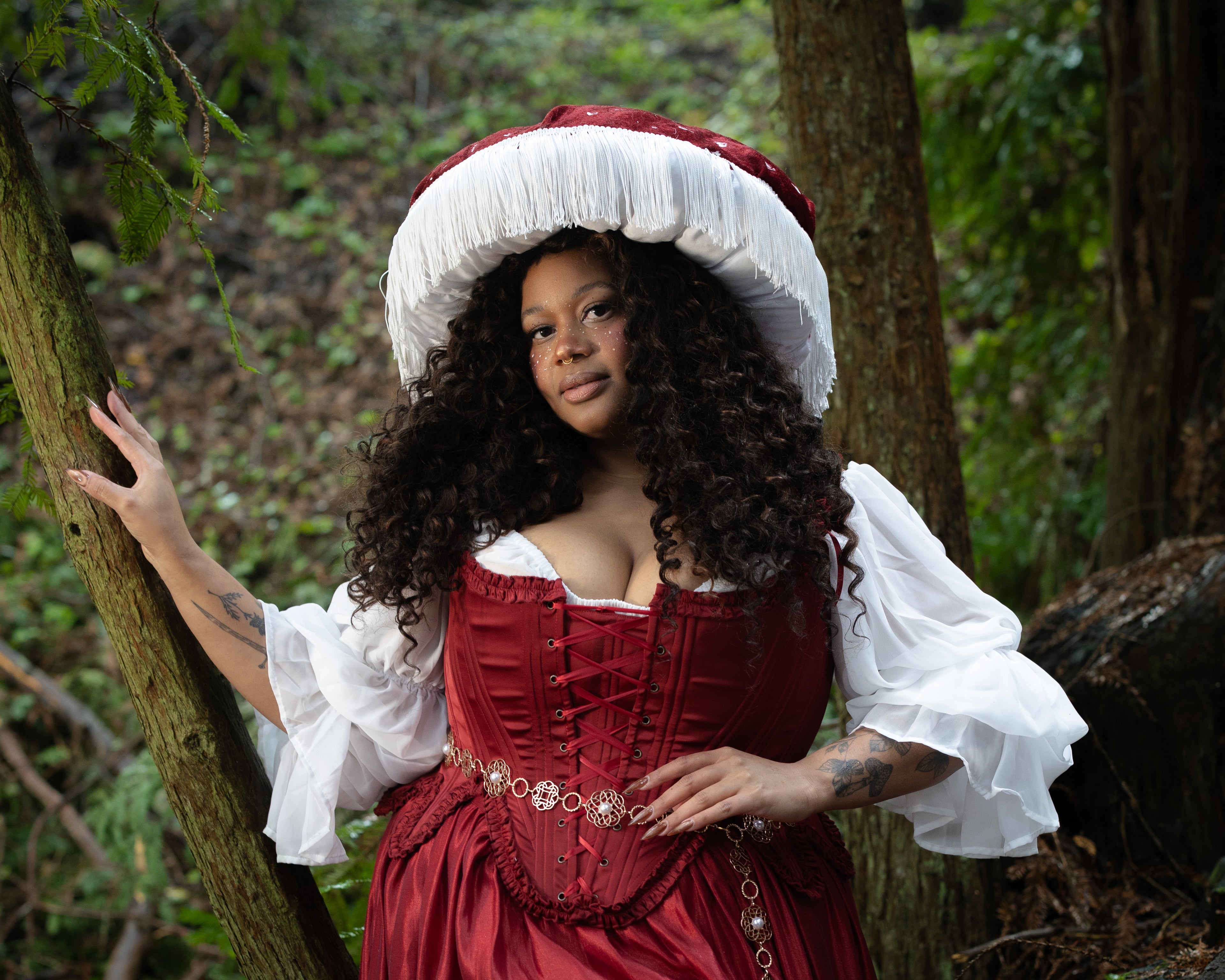 Woman wearing Red Satin 18th Century Stays with ruffle trims and lace-up front in a forest, gallery image two landscape orientation