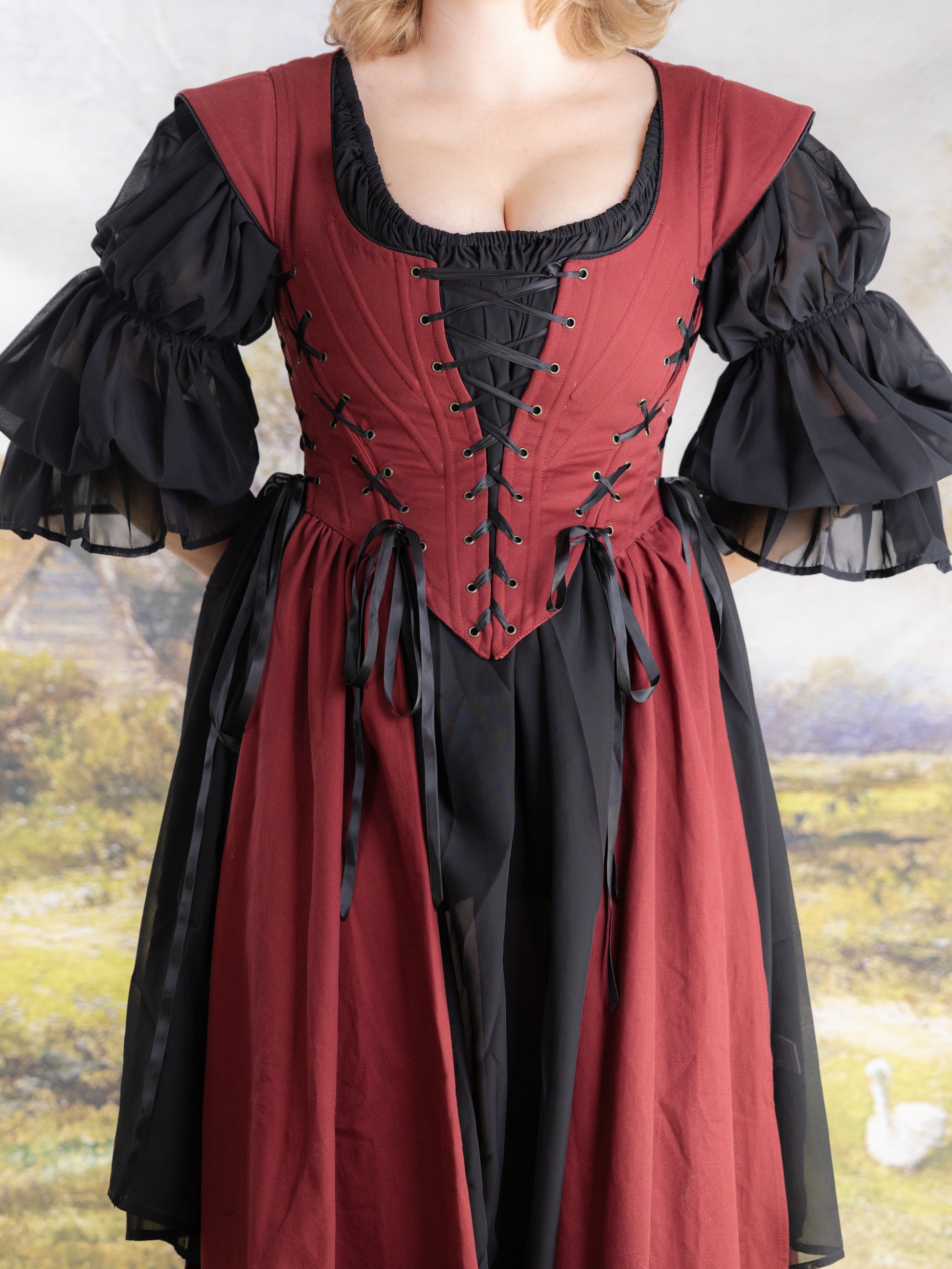Red Vampire Slayer Corset Dress in deep red with black lace-up corset and sheer puffed sleeves.