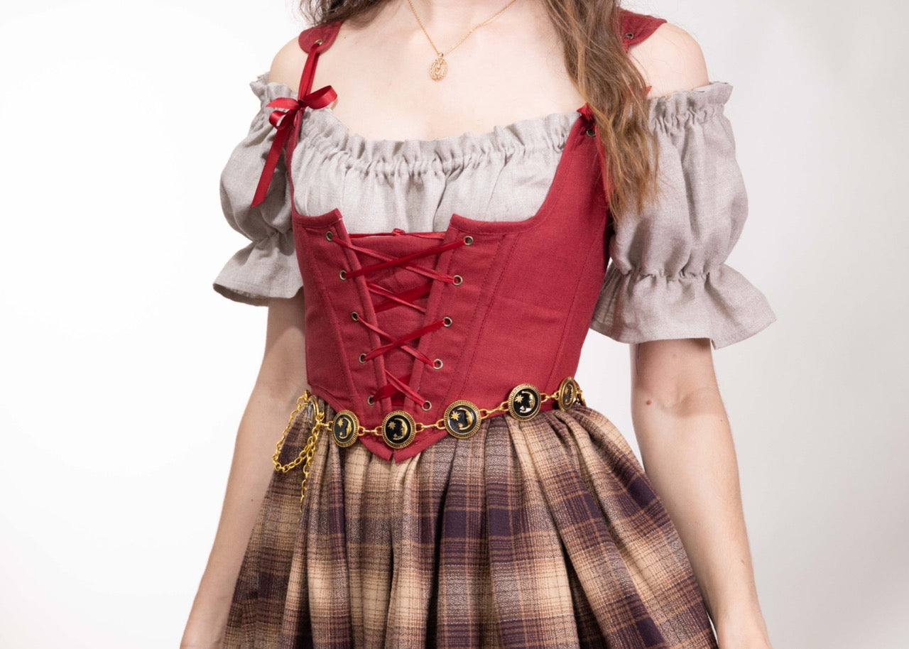 Woman wearing a Handmade Red Linen Corset with lace-up front over an off-shoulder blouse and plaid skirt