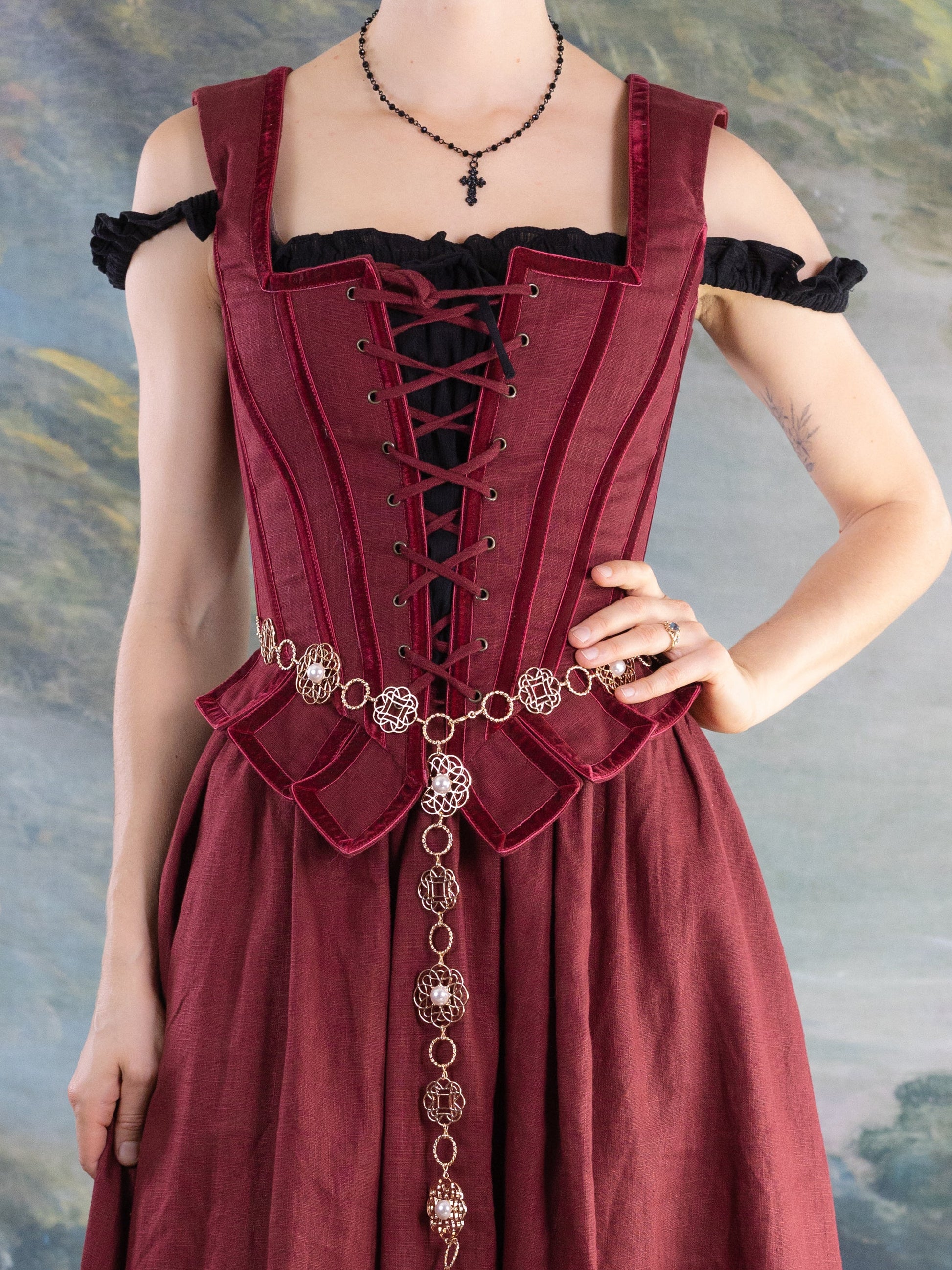 Red Pirate Doublet worn over a black top with decorative lace-up front and gold chain belt on red skirt