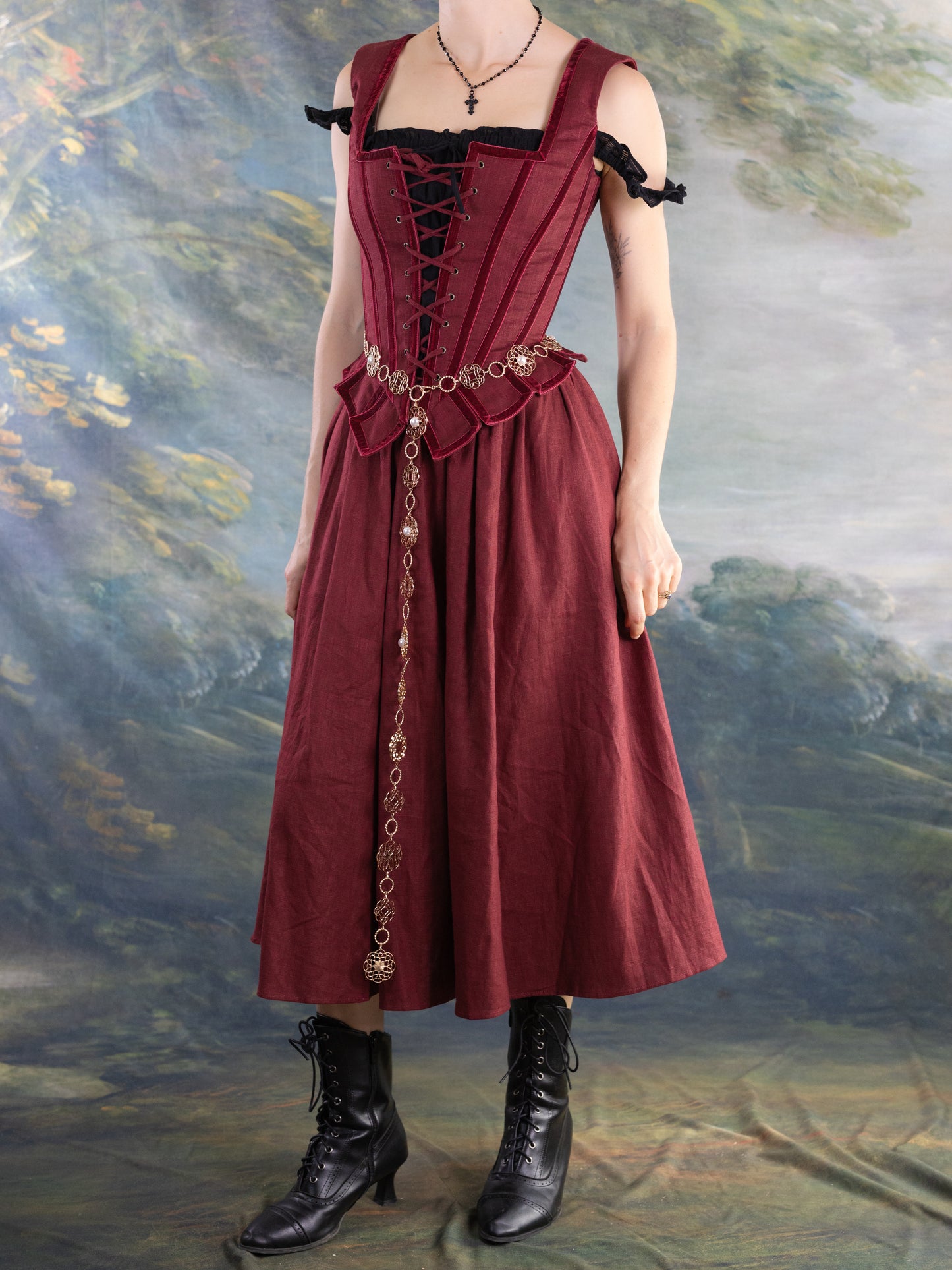 Red Pirate Doublet worn with matching skirt and vintage-inspired accessories in a rustic setting.