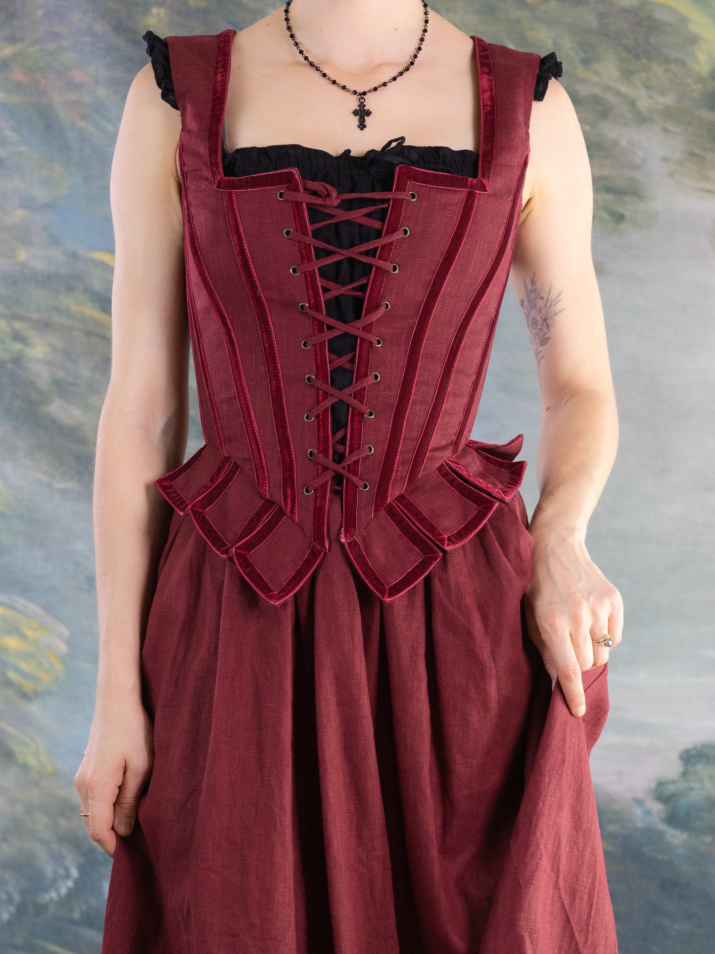 Close-up of a person wearing a red corset-style Red Pirate Doublet with ruffled detailing and black underdress.