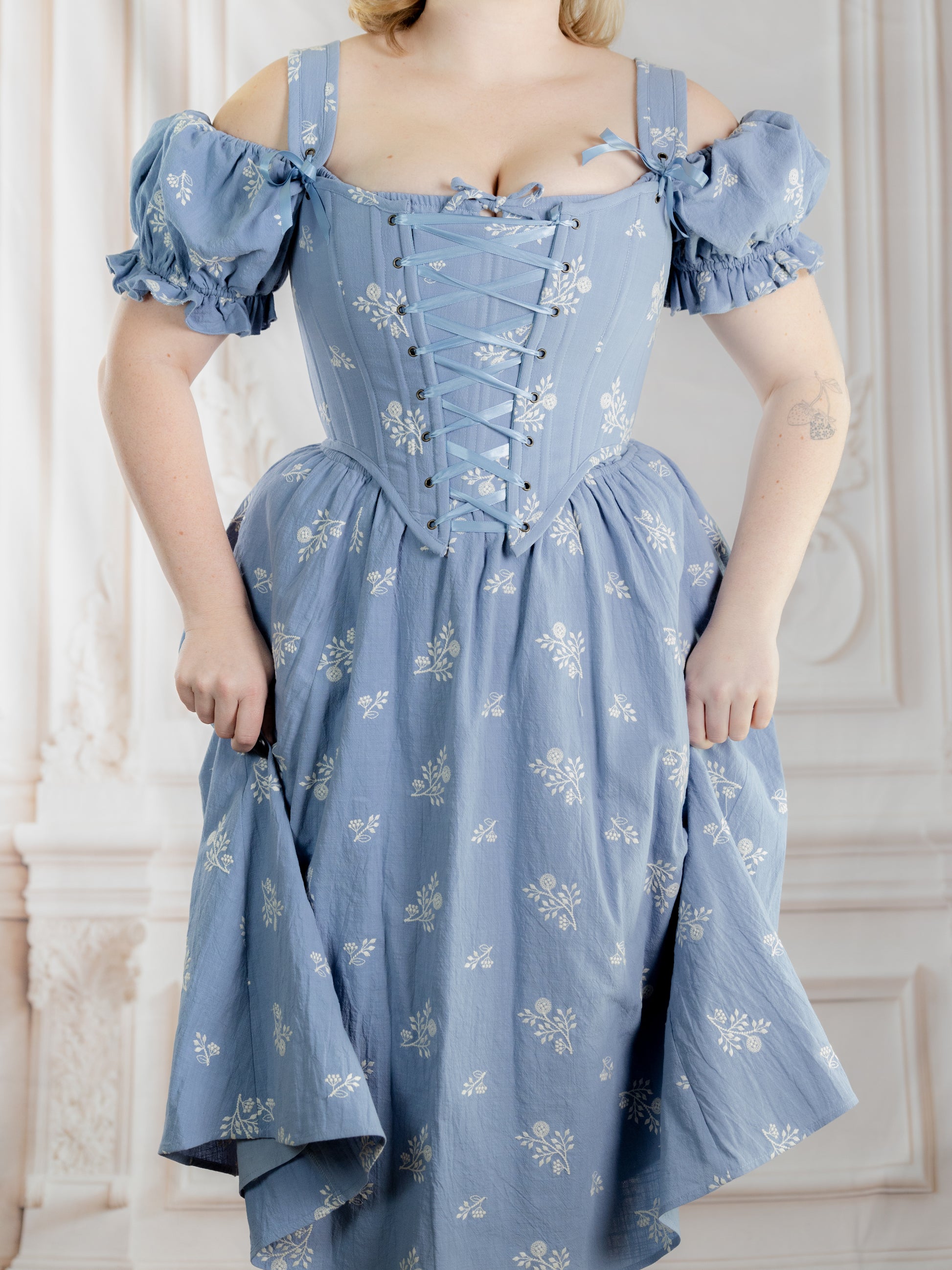 Regency Blue Floral Corset in light blue with white floral pattern and puffed sleeves worn with matching skirt