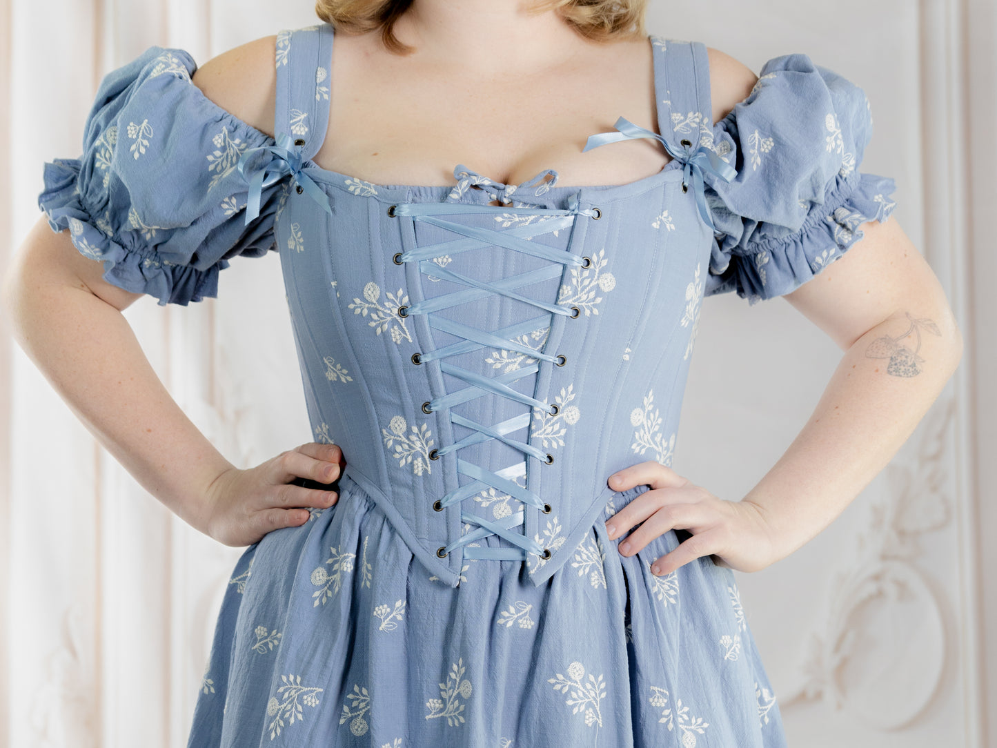 Regency Blue Floral Corset with puff sleeves and lace-up front in delicate blue fabric with white floral print