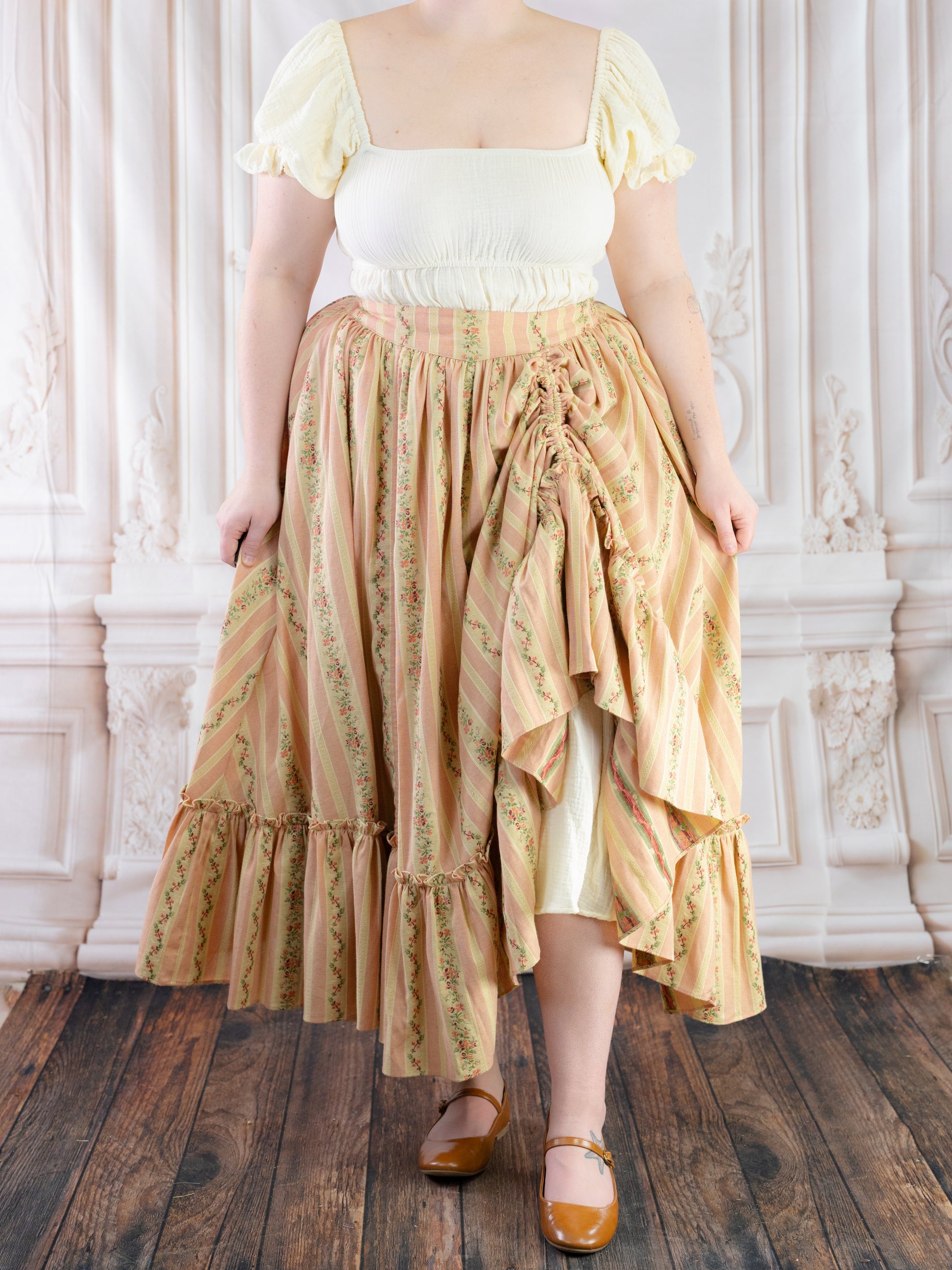 Rococo Pink Ruffle Skirt with floral stripes and adjustable drawstrings styled with a white puff sleeve top and brown shoes