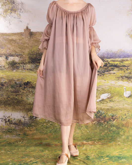 Woman wearing muted rose Rose Chiffon Chemise with gathered neckline and loose sleeves in a soft natural setting