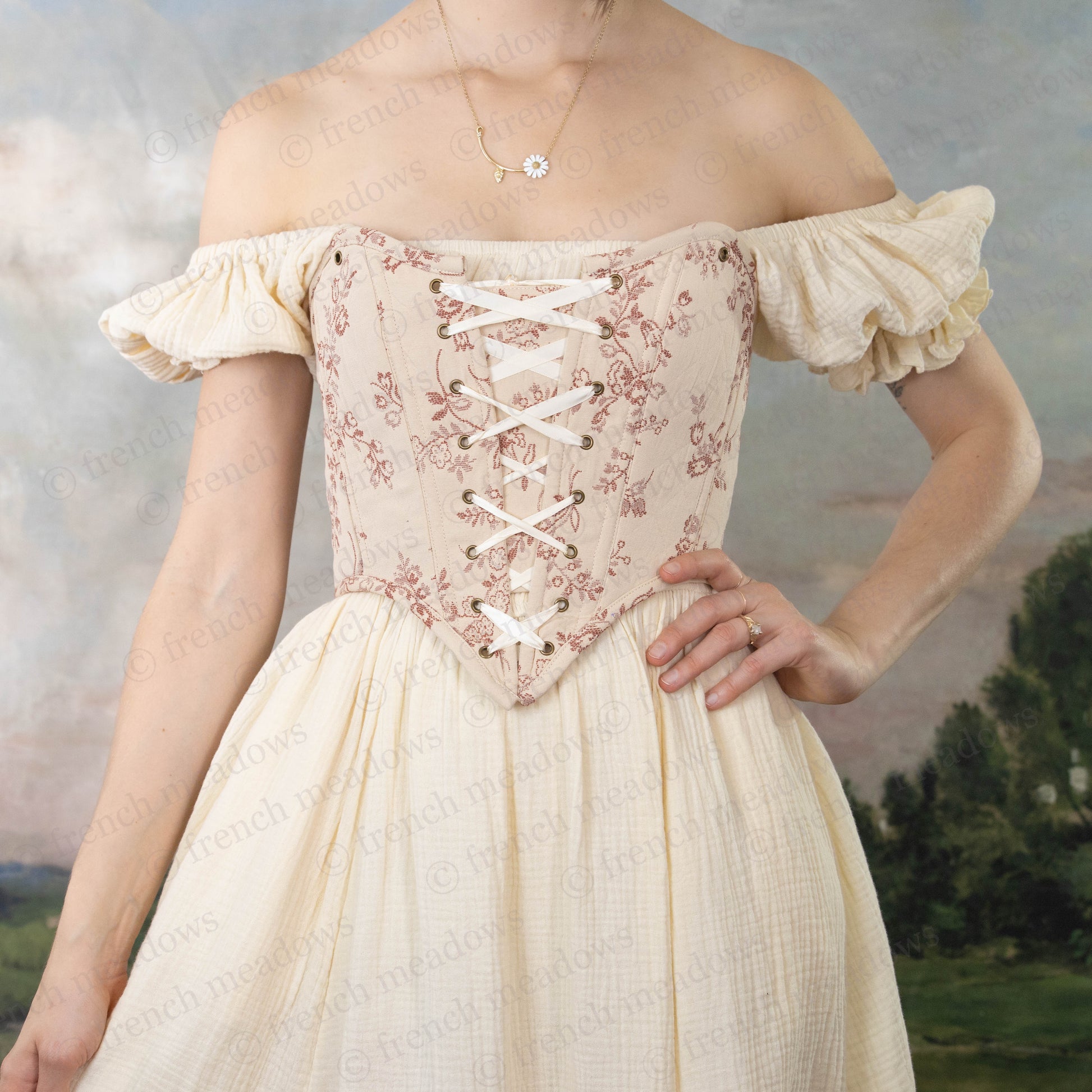 model wearing strapless overbust corset with sweetheart neckline and ivory cotton milkmaid dress