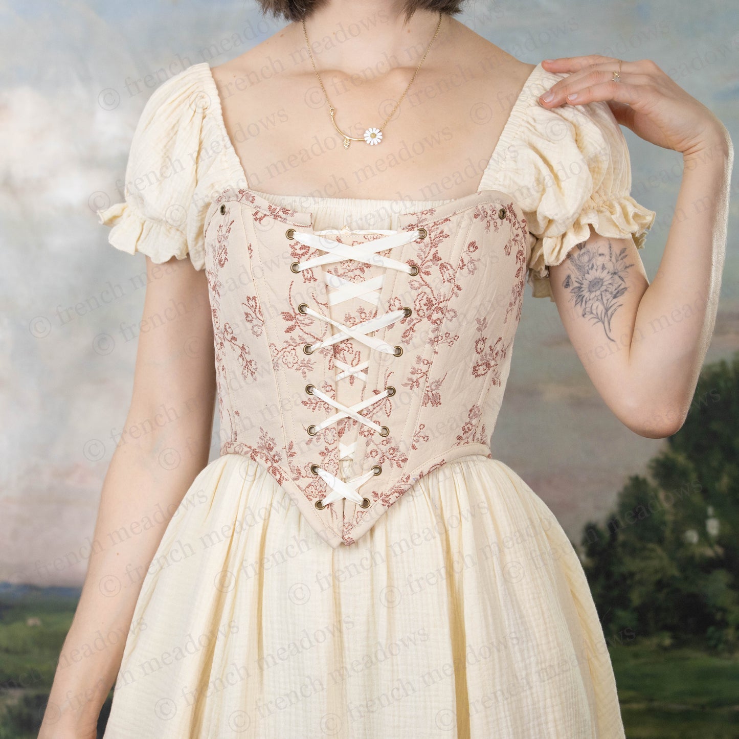 model wearing ivory and pink floral corset with ivory cotton milkmaid dress