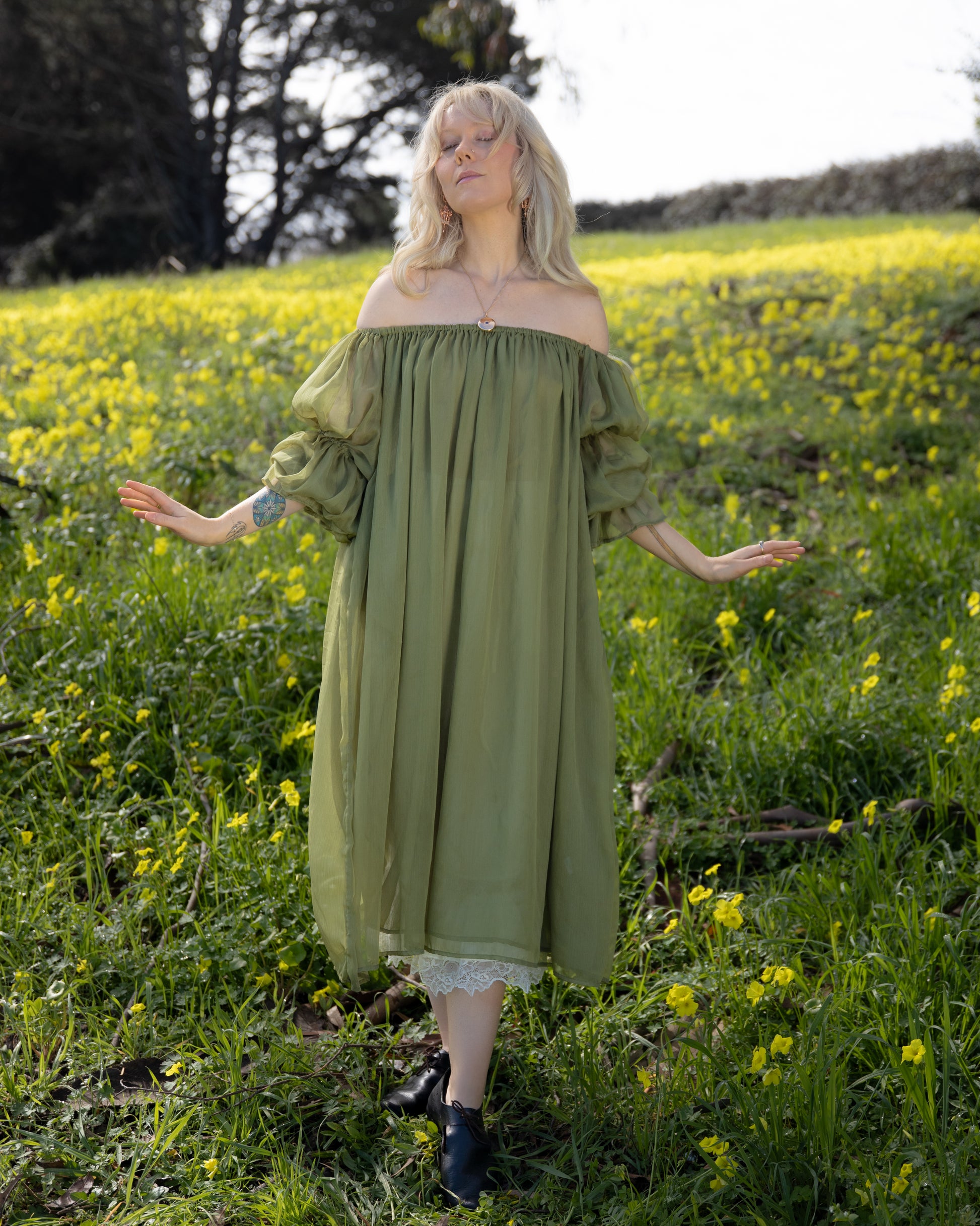 Woman in a field wearing Sage Chiffon Chemise with off-shoulder sleeves, gallery position 4 portrait view