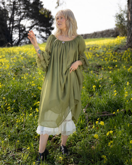 Woman wearing Sage Chiffon Chemise in portrait shot outdoors among yellow wildflowers, gallery position 3