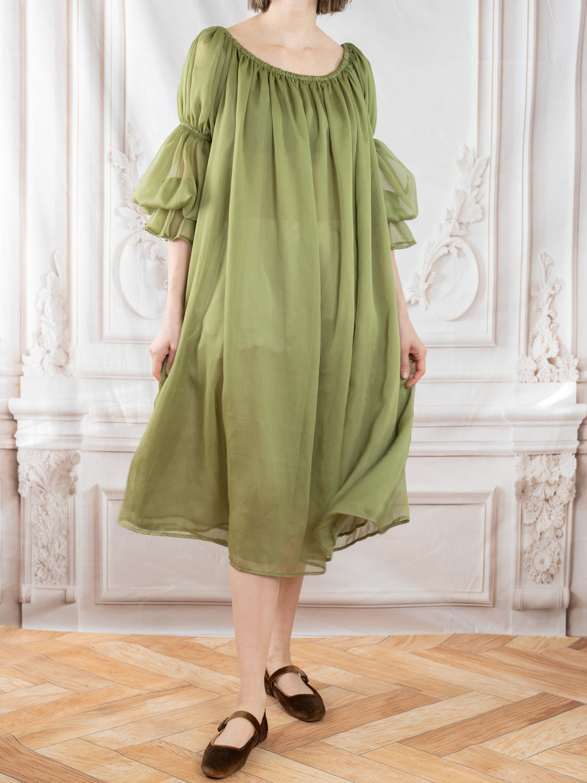 Light, airy Sage Chiffon Chemise with puffed sleeves, flowing gently to mid-calf in an elegant room setting.