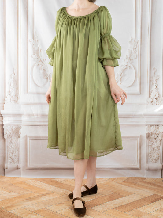 Model wearing flowing Sage Chiffon Chemise with gathered neckline and sheer puff sleeves in soft woodland green tone