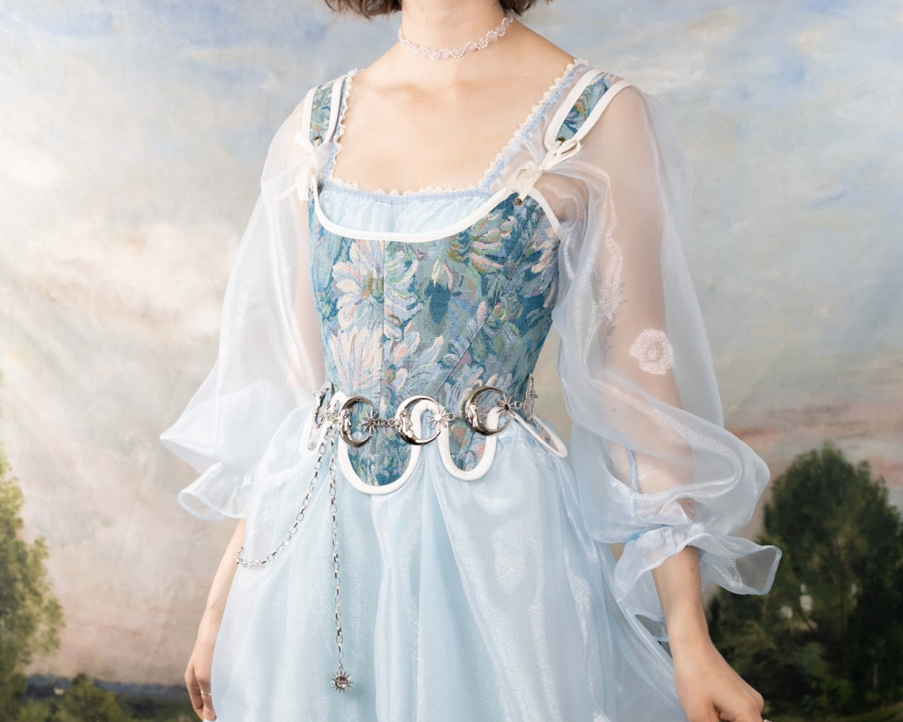 Woman wearing a delicate dress with a sheer overlay and Handmade Teal Floral Tapestry 18th Century Stays corset bodice