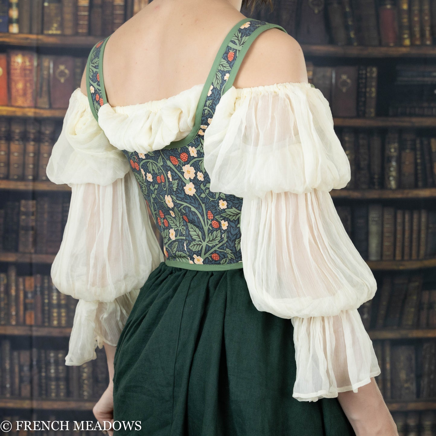 back view of model wearing a green floral corset top